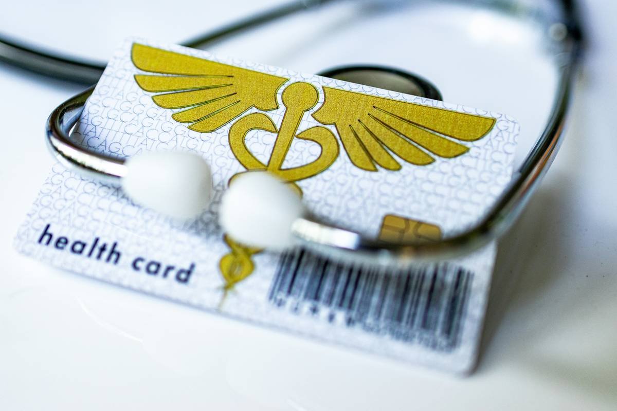 Traveler reviewing credit card travel pre-existing condition coverage documents with frustration