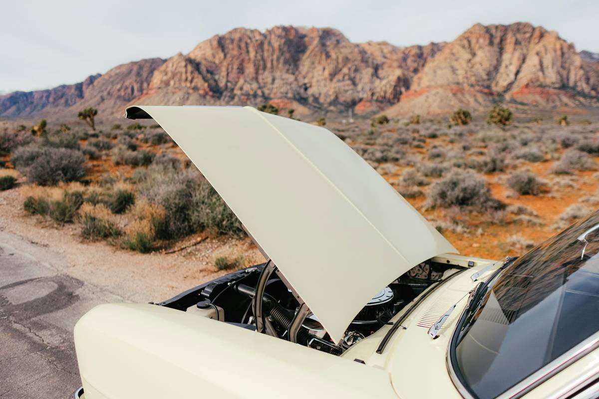 credit card travel insurance emergency roadside assistance: a stranded car on a rural road with a tow truck arriving at dusk