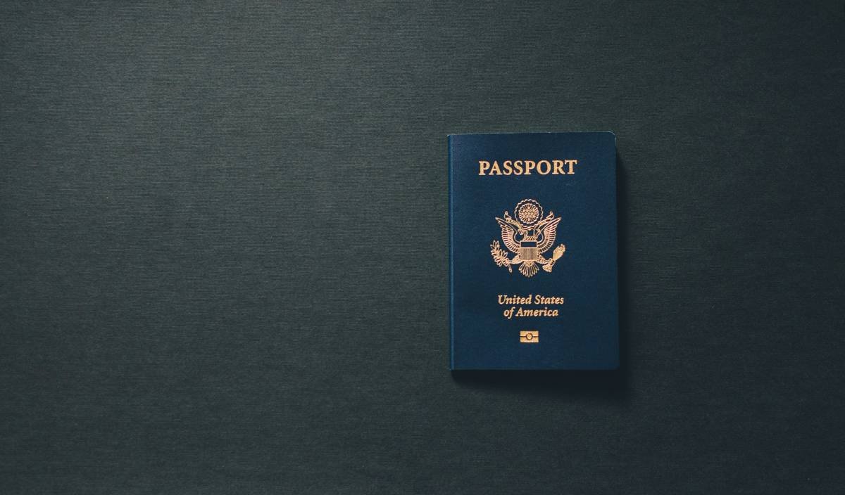 credit card travel insurance claim eligibility checklist on a desk with passport and boarding pass